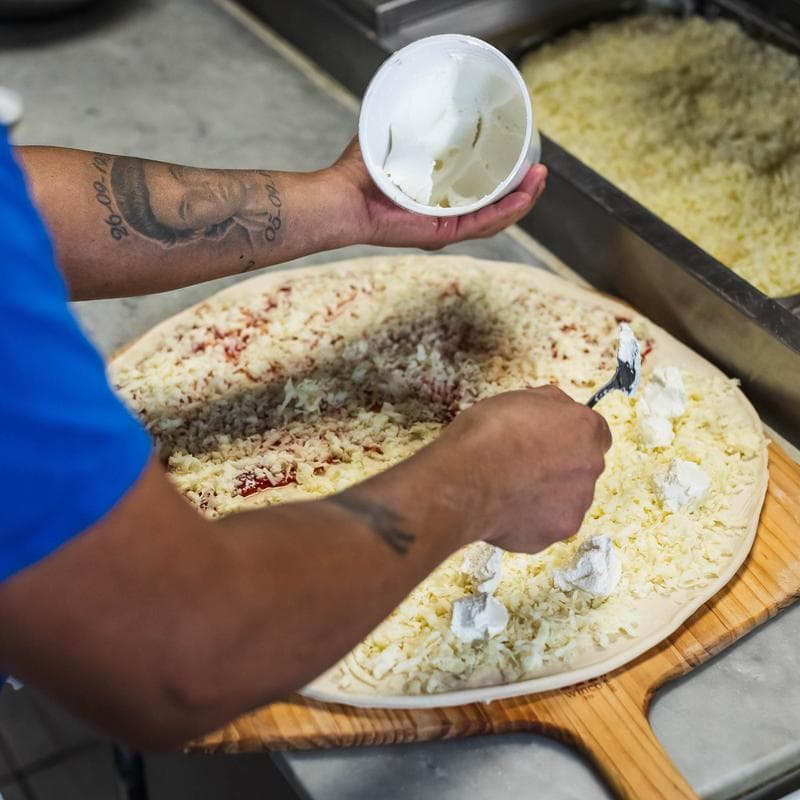 Cheese pizza served in the dining room